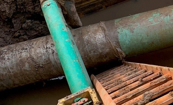 View of pipe in trench after it had been pulled under the roadway. Denso Bore-Wrap™ is still intact so there is no damage to the pipe coating.