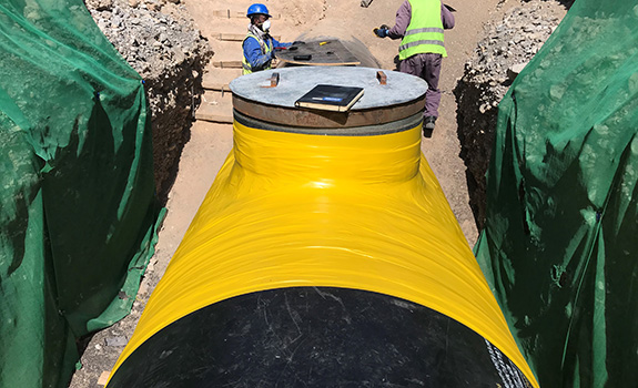 The Densopol 80HT ™ Tape System being applied to pipe tee